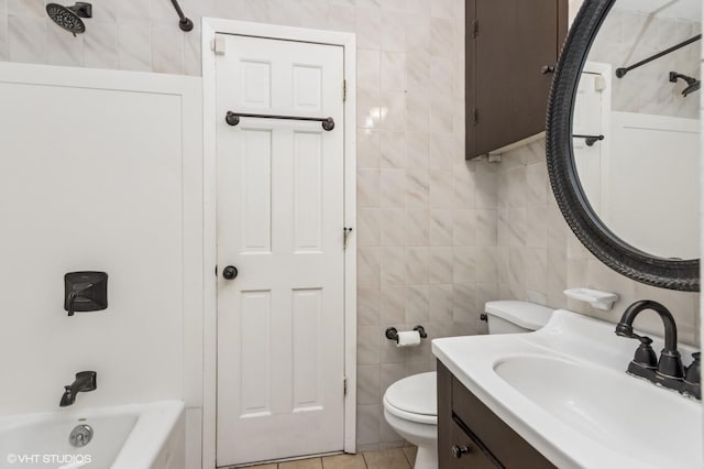 full bathroom with vanity, toilet, tile walls, shower / bathing tub combination, and tile patterned floors