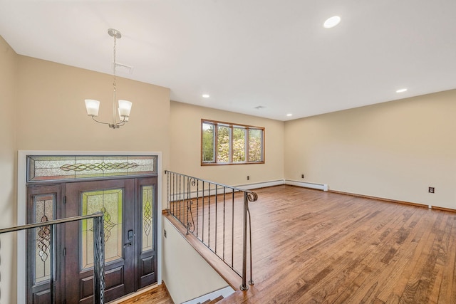 40 Cedarhurst St, Islip Terrace, NY 11752 - foyer with wood finished floors, a chandelier, baseboards, and recessed lighting