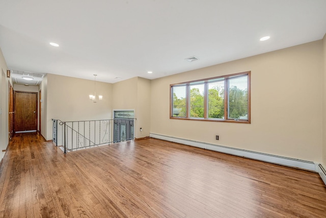 40 Cedarhurst St, Islip Terrace, NY 11752 - unfurnished room featuring wood finished floors, a baseboard heating unit, a chandelier, recessed lighting, and attic access