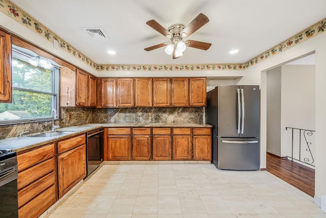 40 Cedarhurst St, Islip Terrace, NY 11752 - kitchen featuring freestanding refrigerator, black dishwasher, brown cabinetry, a sink, and range with gas cooktop