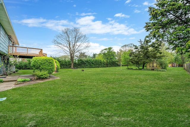 40 Cedarhurst St, Islip Terrace, NY 11752 - view of green lawn featuring a shed, a wooden deck, and an outdoor structure