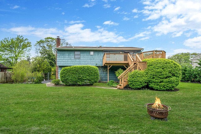40 Cedarhurst St, Islip Terrace, NY 11752 - rear view of house featuring stairway, a fire pit, a deck, and a chimney