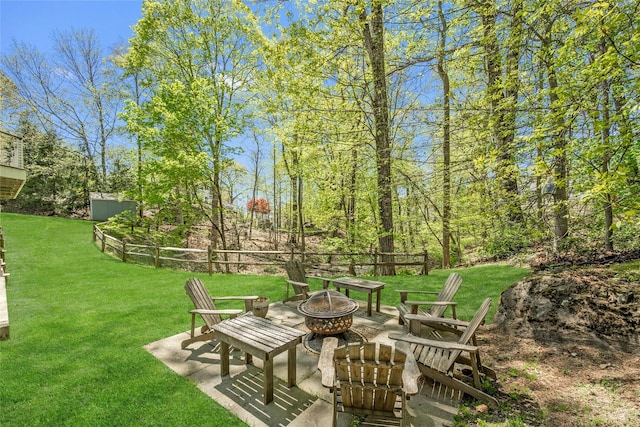 view of yard featuring a patio and an outdoor fire pit