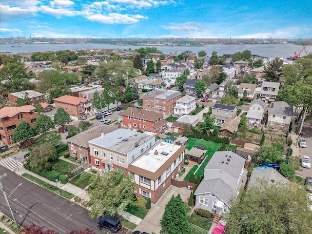 aerial perspective of suburban area with a nearby body of water