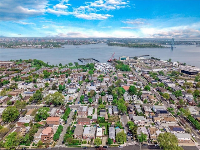 aerial view of property and surrounding area featuring a nearby body of water