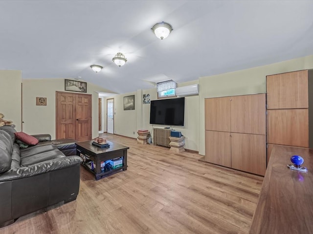 living area featuring light wood-type flooring, vaulted ceiling, and a wall mounted air conditioner
