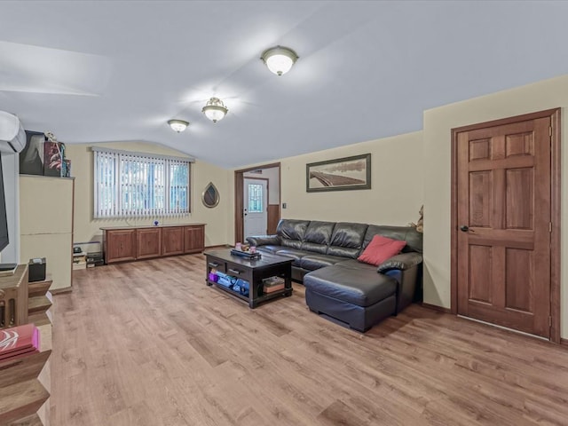 living area featuring lofted ceiling and wood finished floors