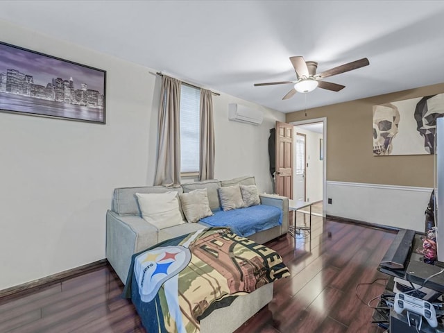 bedroom with wood finished floors, ceiling fan, a wall mounted air conditioner, and baseboards