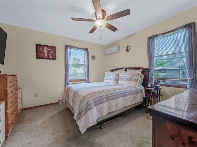 bedroom featuring a wall mounted AC, light carpet, a ceiling fan, and baseboards