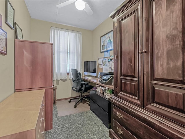 carpeted home office with a ceiling fan and baseboards