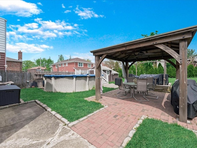 view of patio / terrace featuring a gazebo, area for grilling, a storage shed, outdoor dining area, and an outdoor structure