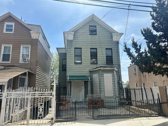 230 Sunnyside Ave, Brooklyn, NY 11207 - view of front of home with cooling unit, a fenced front yard, and a gate