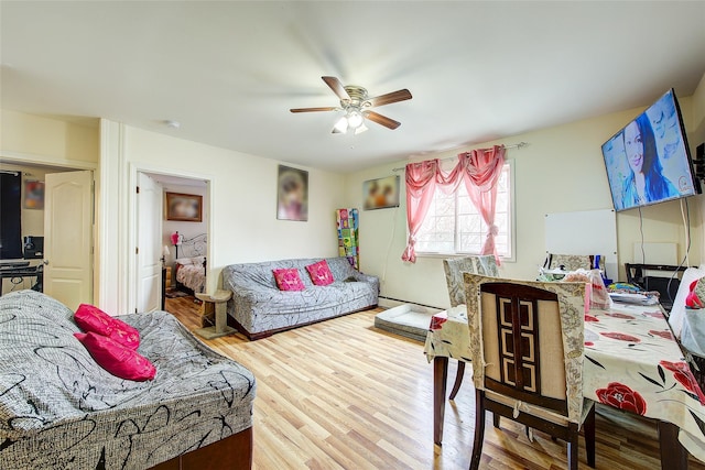 bedroom featuring a baseboard radiator, a ceiling fan, and wood finished floors