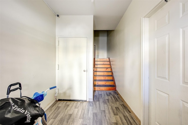 stairs featuring baseboards and wood finished floors