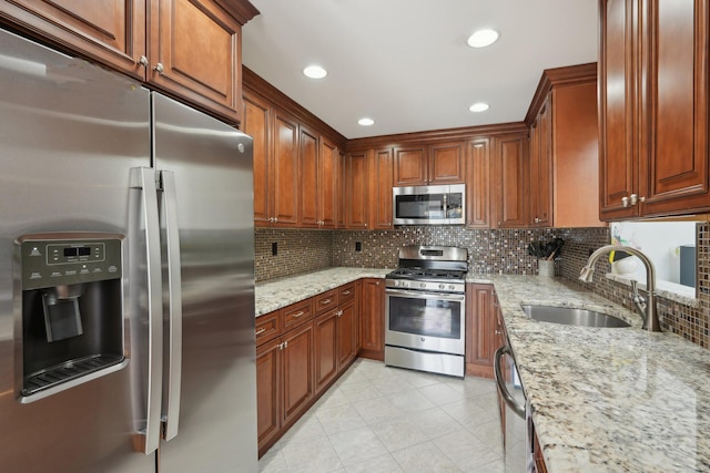 kitchen featuring decorative backsplash, light tile patterned flooring, light stone countertops, a sink, and stainless steel appliances