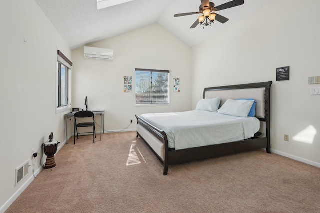 carpeted bedroom with baseboards, visible vents, lofted ceiling with skylight, and a wall mounted air conditioner
