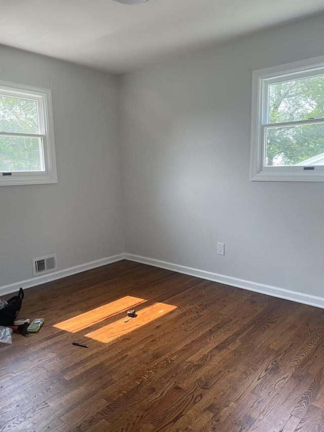 47 Ontario St, Port Jefferson Station, NY 11776 - unfurnished room with visible vents, dark wood-style flooring, and a healthy amount of sunlight