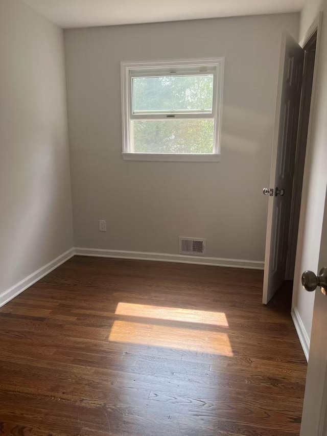 47 Ontario St, Port Jefferson Station, NY 11776 - unfurnished bedroom with baseboards, visible vents, and dark wood-type flooring