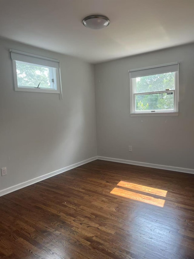47 Ontario St, Port Jefferson Station, NY 11776 - spare room with baseboards and dark wood-type flooring