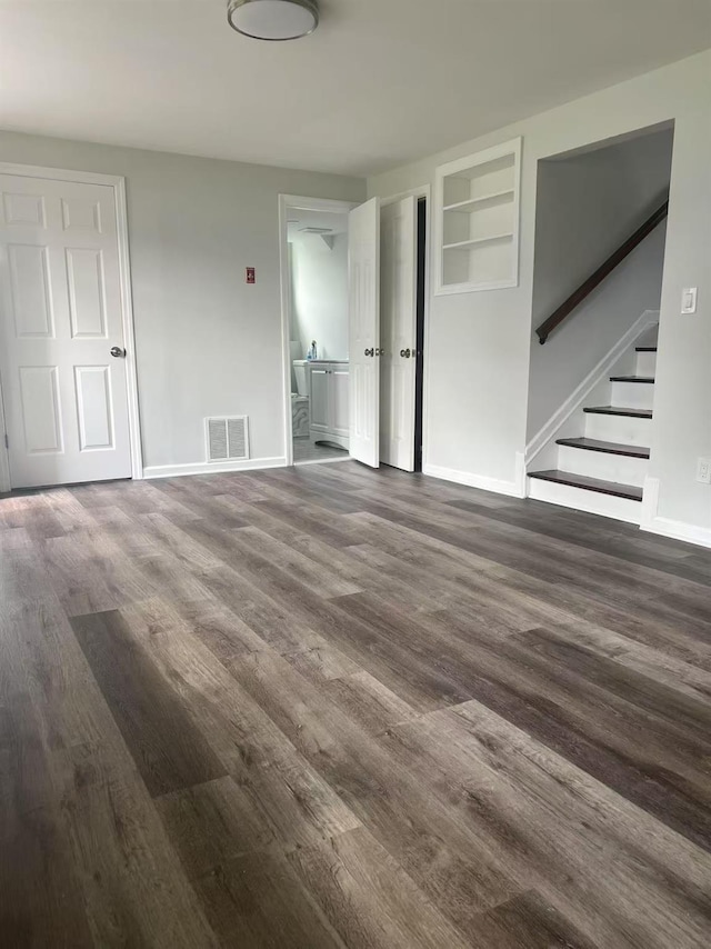 47 Ontario St, Port Jefferson Station, NY 11776 - unfurnished living room with visible vents, baseboards, stairs, and wood finished floors