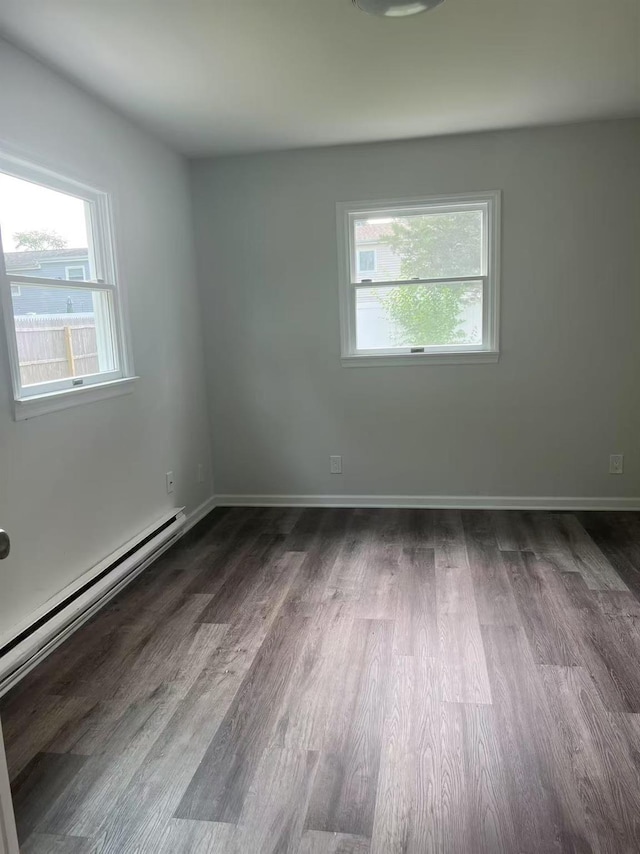 47 Ontario St, Port Jefferson Station, NY 11776 - unfurnished room featuring baseboards, baseboard heating, and wood finished floors