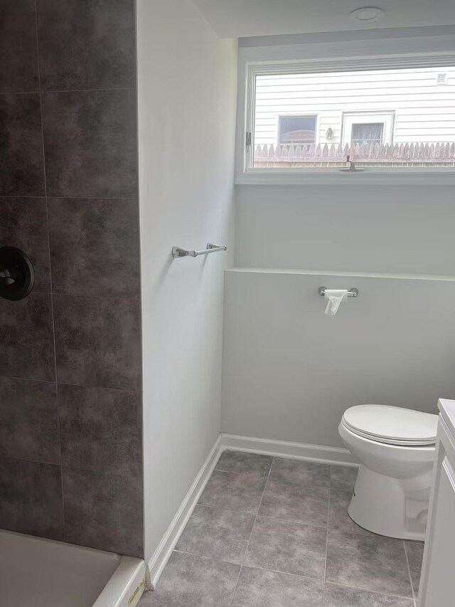 47 Ontario St, Port Jefferson Station, NY 11776 - full bathroom featuring baseboards, tile patterned flooring, a tile shower, and toilet