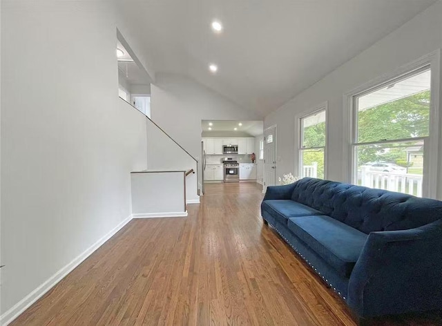 47 Ontario St, Port Jefferson Station, NY 11776 - living area featuring stairs, wood finished floors, baseboards, recessed lighting, and vaulted ceiling