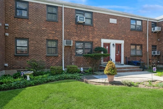 19-32 202nd St Apt # 1-179, Whitestone, NY 11360 - view of property featuring brick siding, cooling unit, and a front lawn