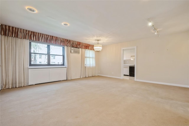 19-32 202nd St Apt # 1-179, Whitestone, NY 11360 - unfurnished living room with light colored carpet, baseboards, a notable chandelier, and a wall mounted air conditioner