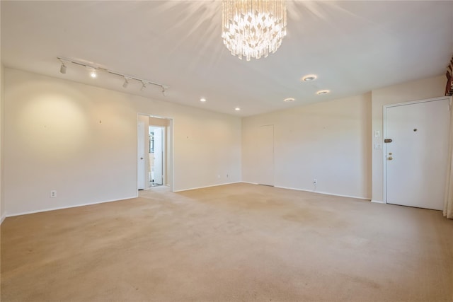 19-32 202nd St Apt # 1-179, Whitestone, NY 11360 - unfurnished room featuring track lighting, baseboards, light carpet, and a chandelier