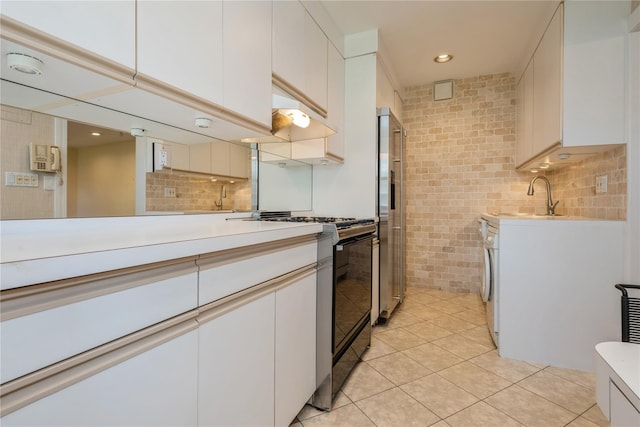 19-32 202nd St Apt # 1-179, Whitestone, NY 11360 - kitchen with range with gas stovetop, high end fridge, light countertops, a sink, and light tile patterned floors