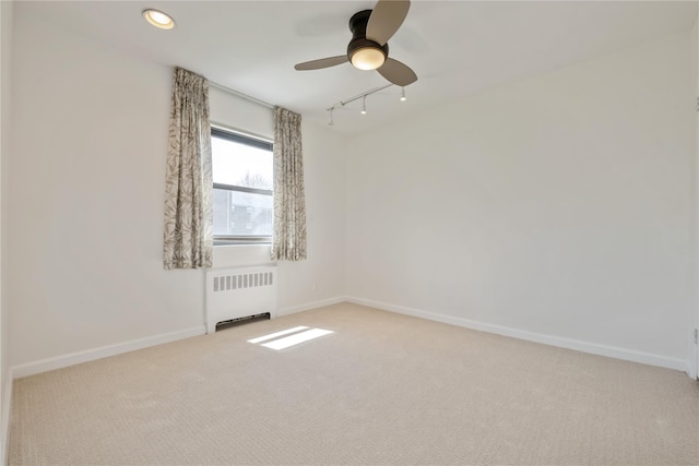 19-32 202nd St Apt # 1-179, Whitestone, NY 11360 - carpeted spare room with radiator heating unit, baseboards, ceiling fan, and rail lighting