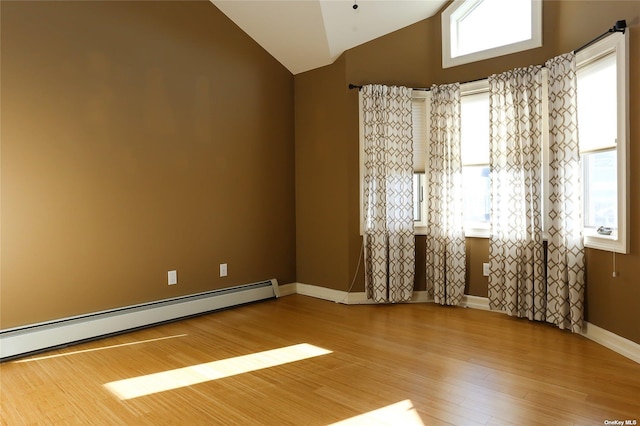 unfurnished room with baseboards, a baseboard heating unit, wood finished floors, and lofted ceiling