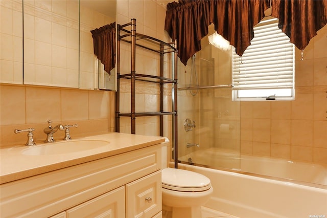 bathroom with vanity, washtub / shower combination, toilet, and tile walls