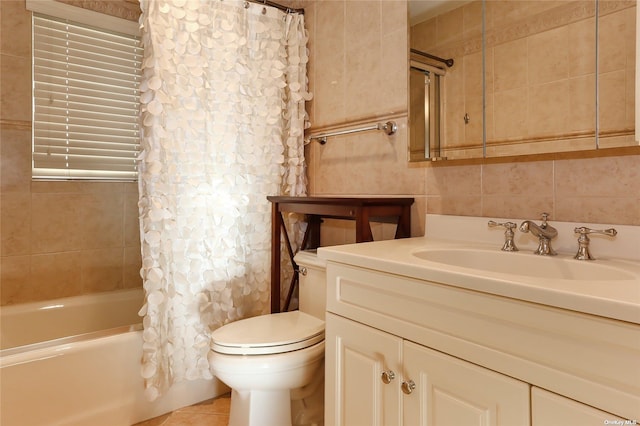 full bathroom featuring tile patterned flooring, shower / bath combo, vanity, toilet, and tile walls