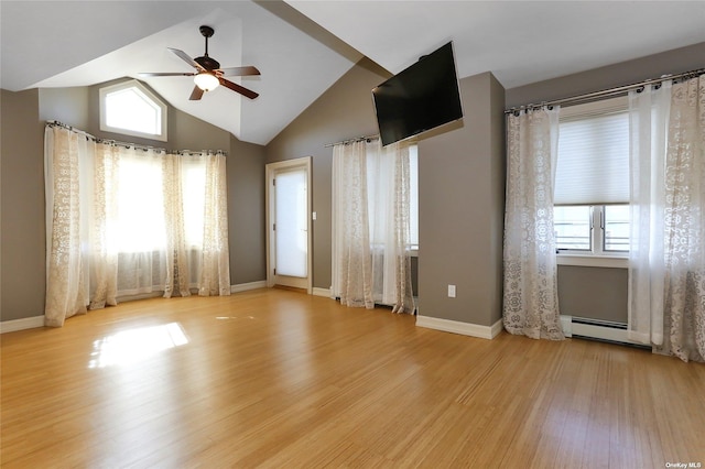 unfurnished room with a ceiling fan, baseboards, wood finished floors, lofted ceiling, and a baseboard heating unit