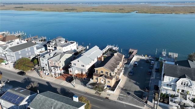 birds eye view of property with a water view and a residential view