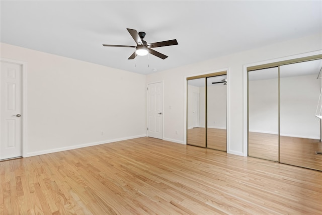 405 Driftway Ln, Brewster, NY 10509 - unfurnished bedroom with multiple closets, light wood-style flooring, baseboards, and ceiling fan