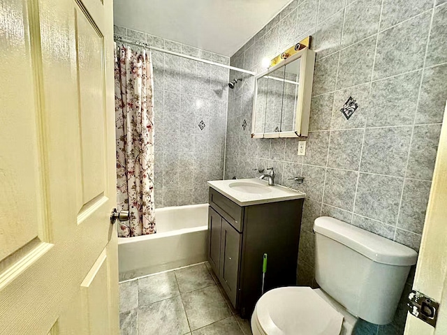 full bathroom with vanity, toilet, tile walls, and shower / bath combo with shower curtain