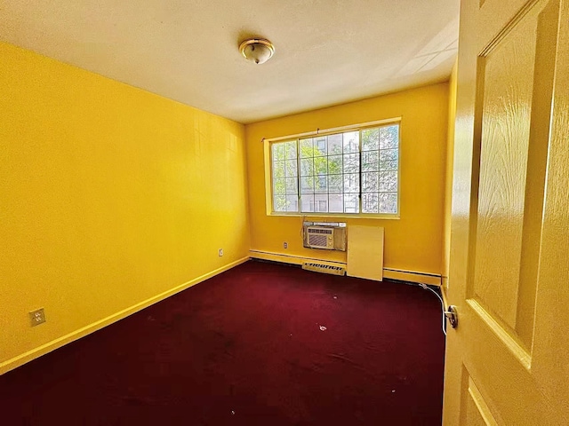 spare room with baseboards, baseboard heating, an AC wall unit, and dark colored carpet