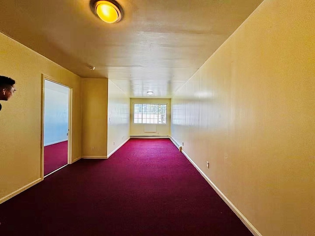 carpeted empty room with baseboards