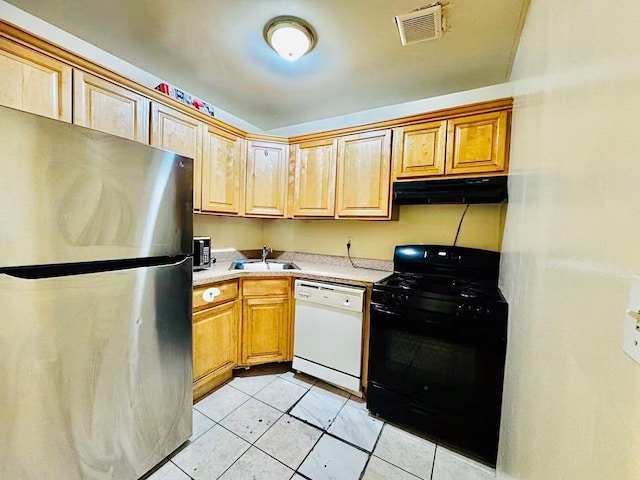 kitchen with freestanding refrigerator, white dishwasher, under cabinet range hood, a sink, and gas stove