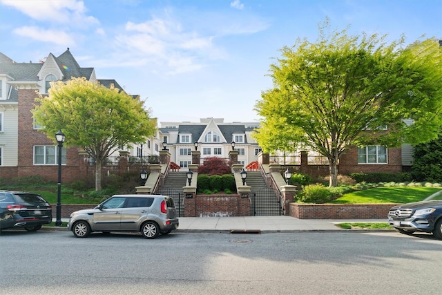 view of front of property with stairs and a residential view