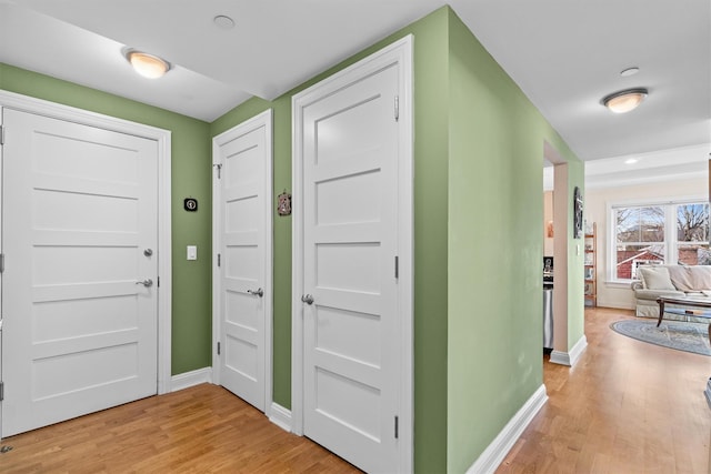 foyer entrance featuring baseboards and light wood-type flooring