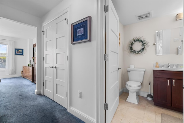 bathroom with visible vents, baseboards, toilet, and vanity
