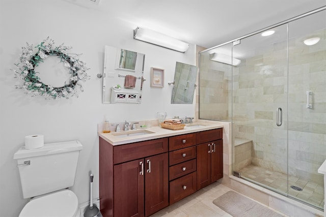 full bath with double vanity, a sink, toilet, and a shower stall