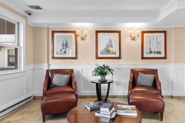 sitting room featuring a decorative wall, a baseboard heating unit, visible vents, and a wainscoted wall