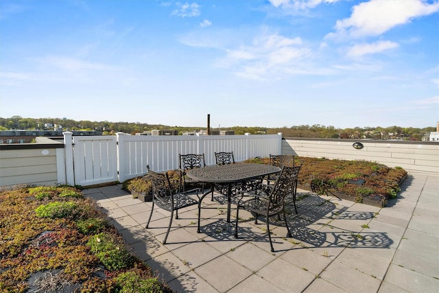 view of patio with outdoor dining area and fence