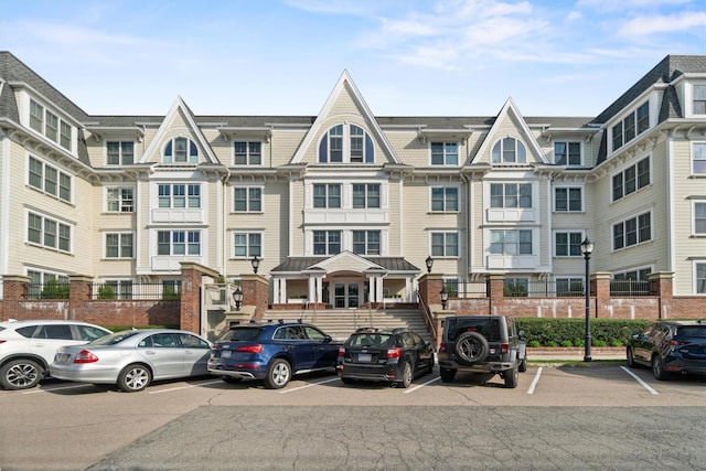 view of building exterior with uncovered parking