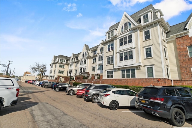 view of building exterior featuring uncovered parking